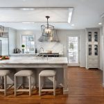 Long Gray Kitchen Island with Gray Upholstered Backless Stools .