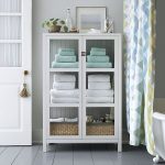Clean-lined classic cabinet frames books, linens, cookware and .