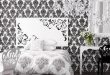 Calming the busy damask patterns on walls and bed cover with black .