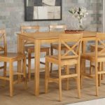 Capri counter height rectangular dining table + 4 wood chairs .