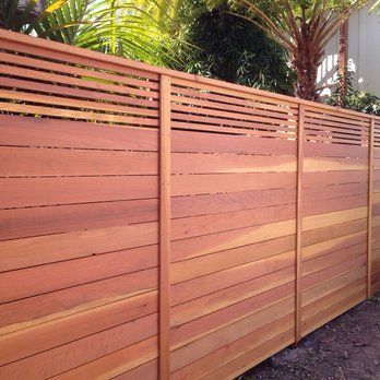 Custom horizontal fence with picket accent top.. Stained natural .