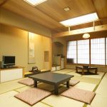 Japanese style living room with wood and bamboo furniture .