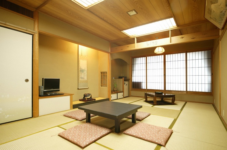 Japanese style living room with wood and bamboo furniture .