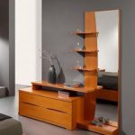 Layered dresser design, with a tall mirror sided with shelves and .