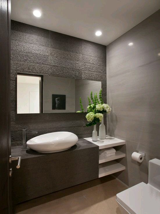 Modern bathroom. I love the sink and the wall. The square toilet .