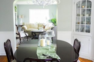 Traditional Dining Room with White Chandelier and Dark Table .