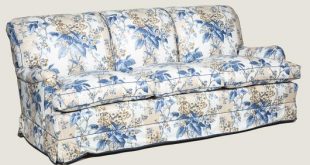 A large three seat sofa in a traditional style upholstered in a .