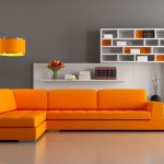 Modern living room design with bright orange sectional sofa, grey .