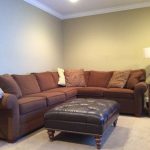 Wall decorations above L shaped sectional cou