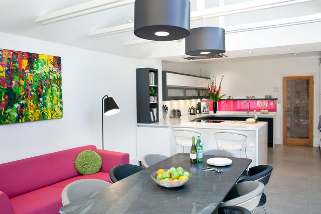 Monochrome kitchen diner with colourful artwork, sofa and bright .
