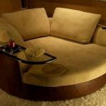 Brown oversized swivel chair for living room with arm table .