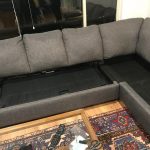 Grey sectional couch w/ pull out bed - excellent condition .