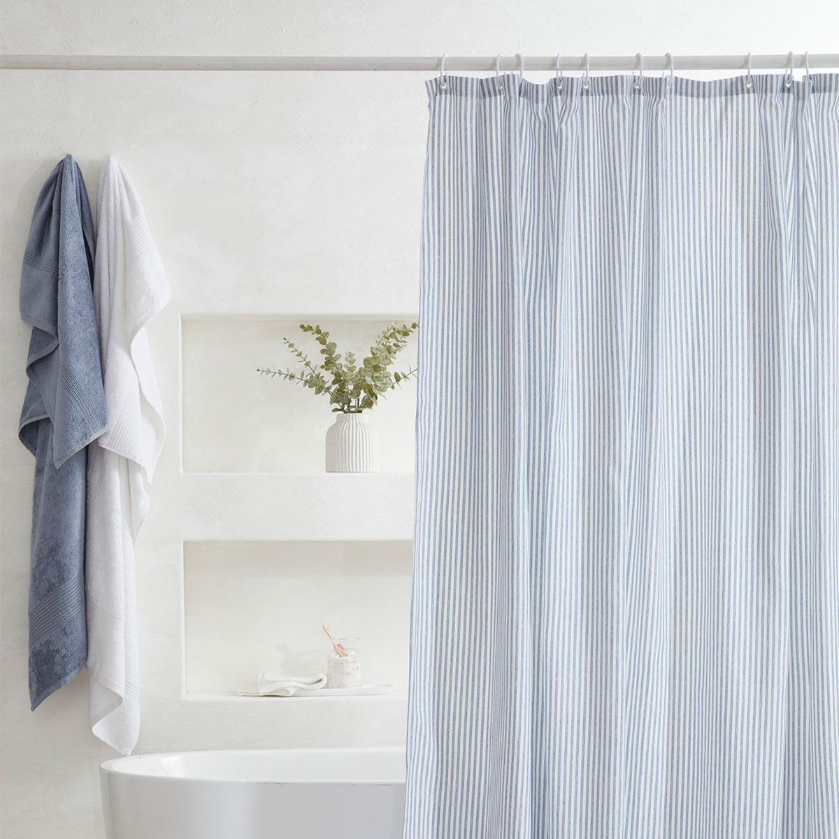 Add a touch of nautical style to your bathroom with a blue and white striped shower curtain