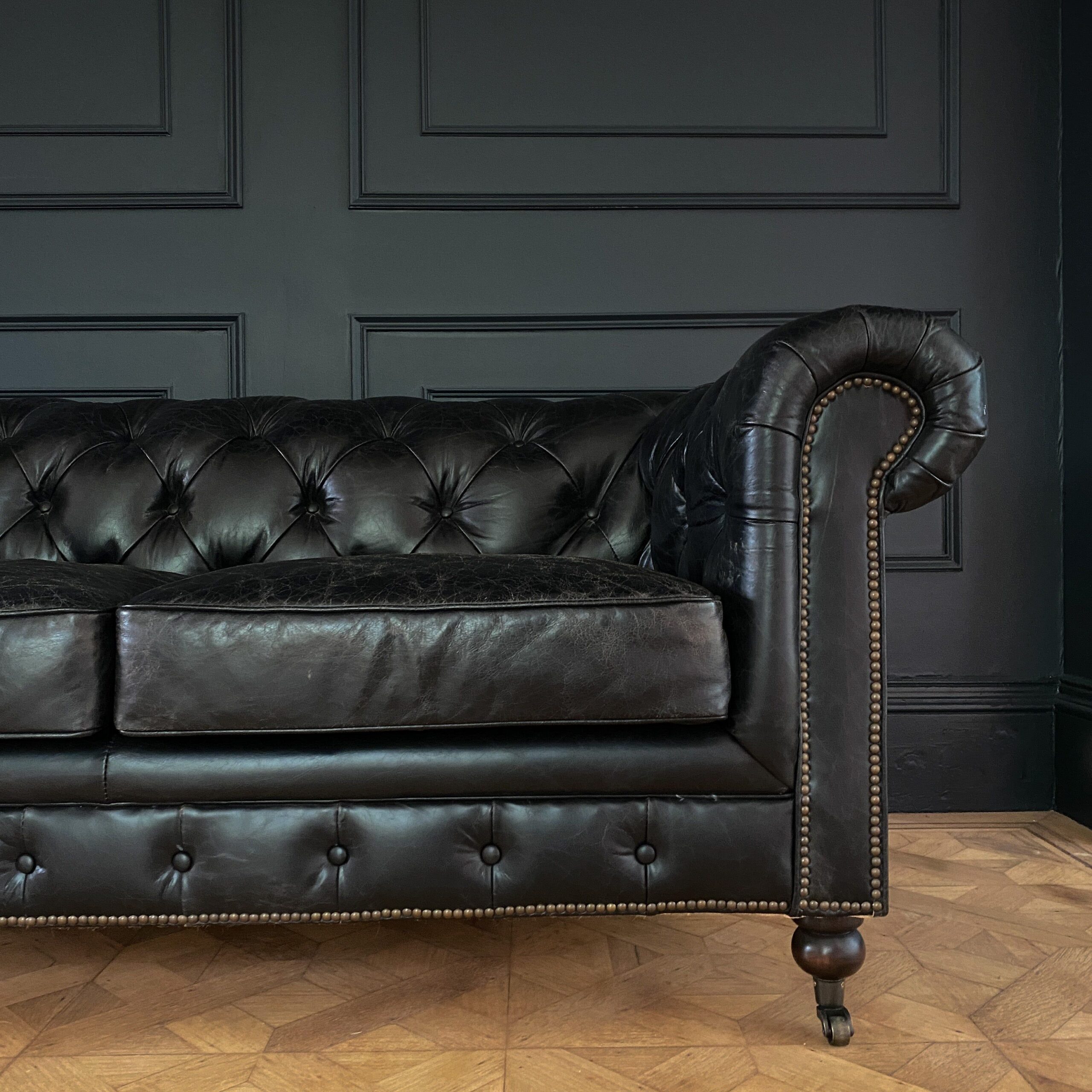 Comfort and Style: The Timeless Elegance of a Black Leather Chesterfield Sofa